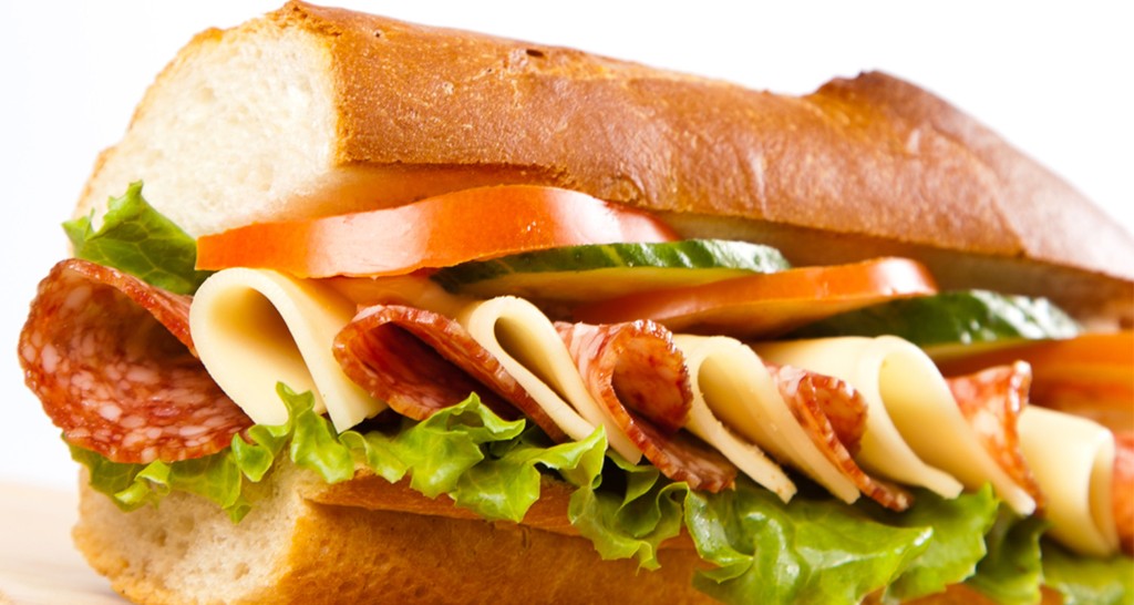 Italian deli sandwich with salami, cheese, tomato and lettuce